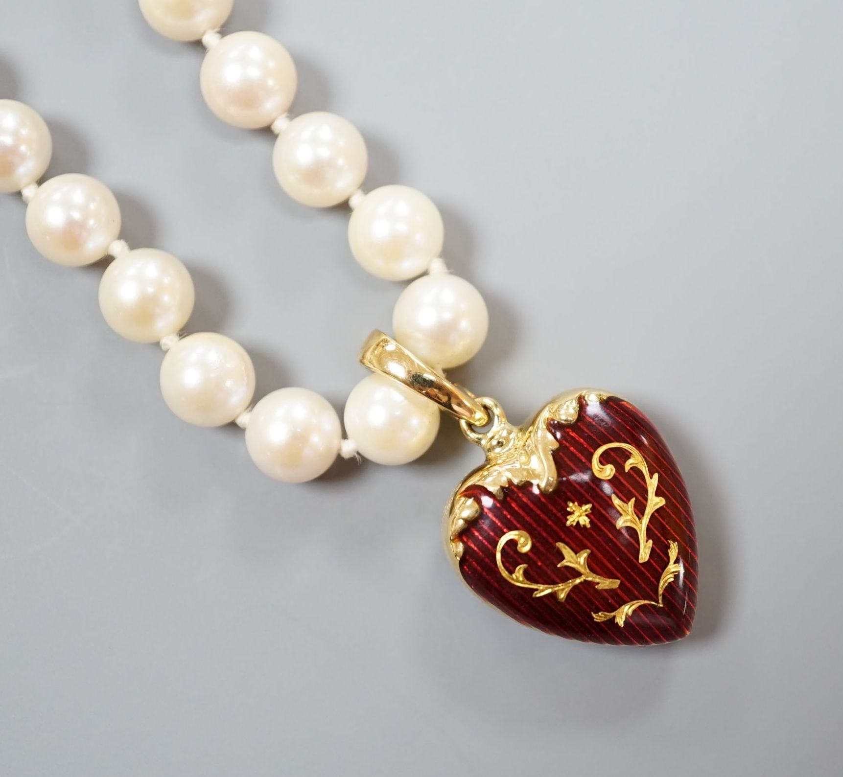 A modern Victor Mayer for Faberge 18ct gold and red guilloche enamel pendant, 19mm, on a single strand cultured pearl necklace, with 14k clasp, 50cm, gross weight 30.7 grams, with box and certificate.